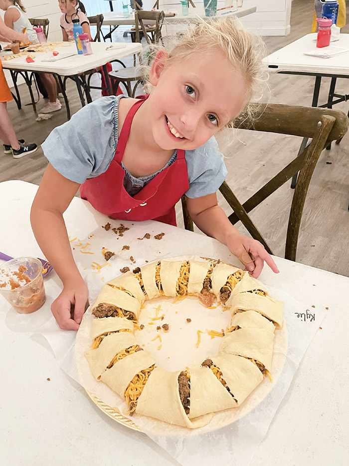 Girl posing with a taco dinner ring she made at Hewitt Oaks Kids Summer Camp