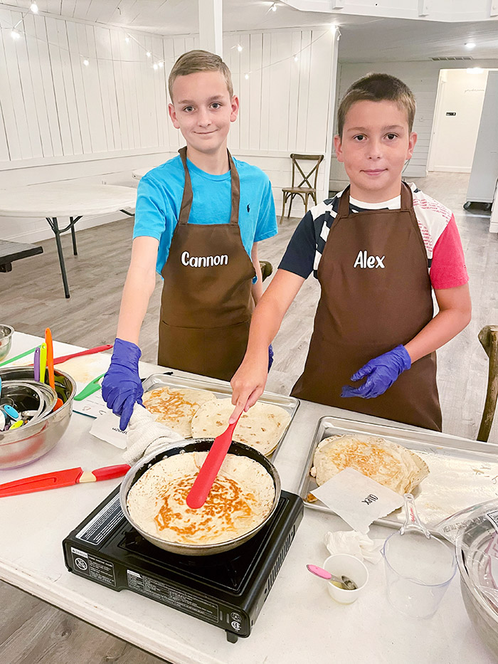 boys making quesadillas at Hewitt Oaks Cooking Camp