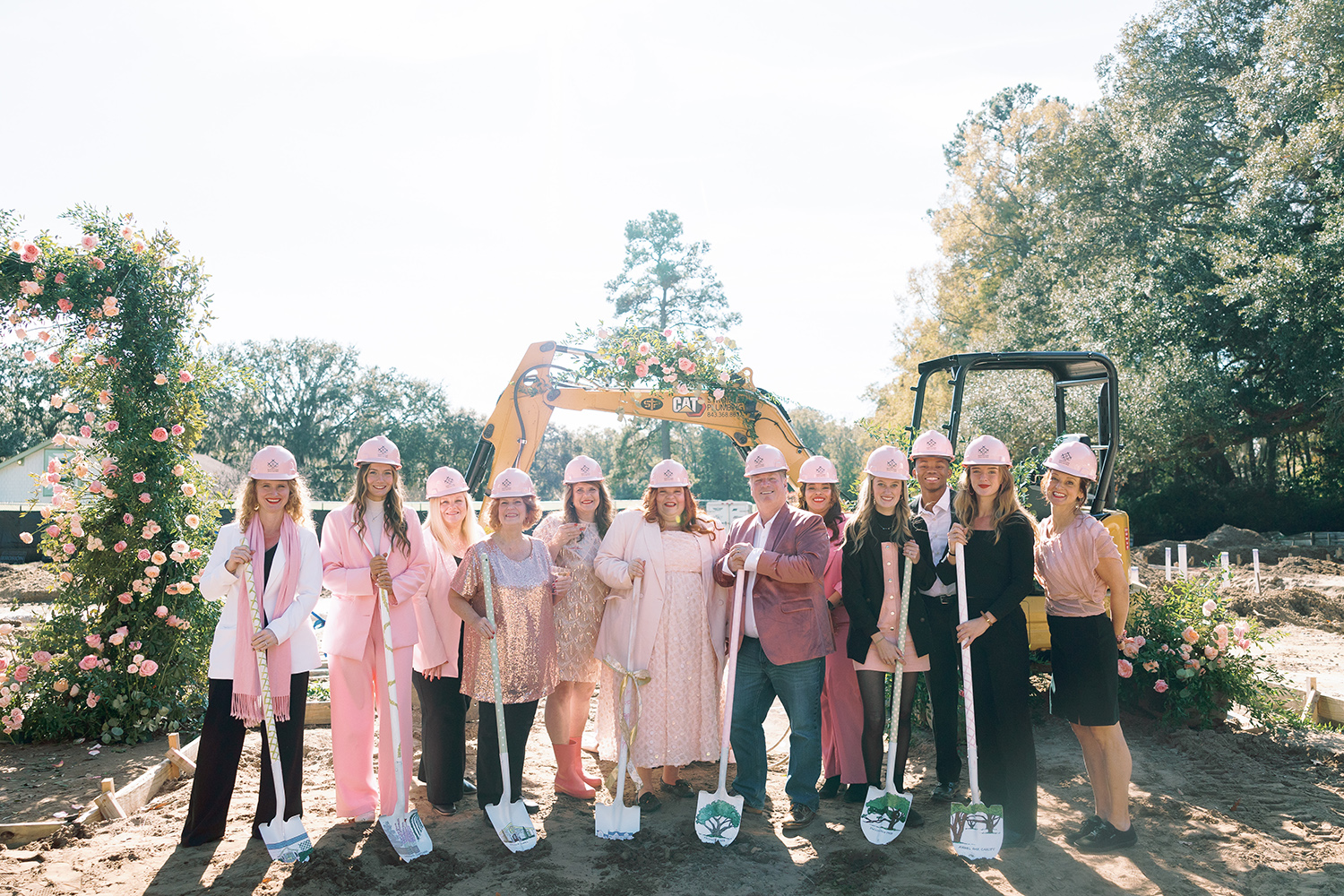 Hewitt Oaks team in pink hard hats with shovels at the groundbreaking for Hewitt House