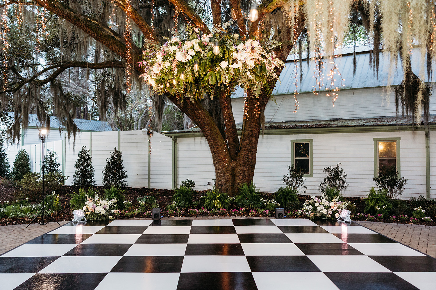 Outdoor dance floor decorated with a floral chandelier