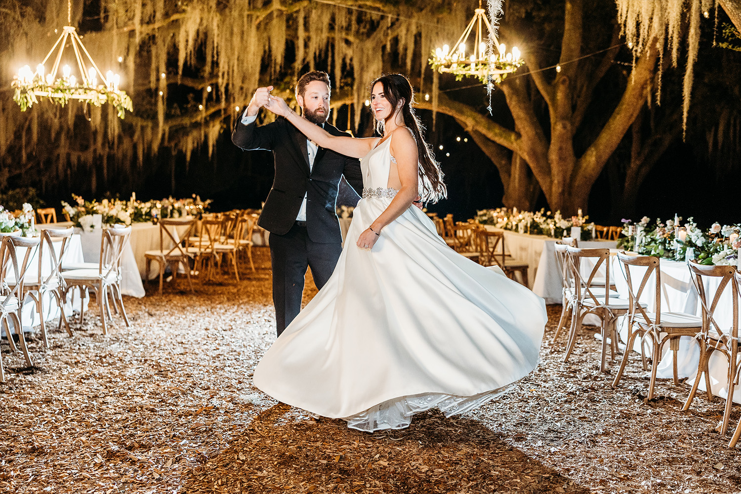 Bride and groom dancing in the center of the outdoor venue