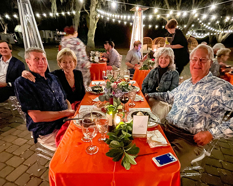 Friends smiling at a Hewitt Oaks community event