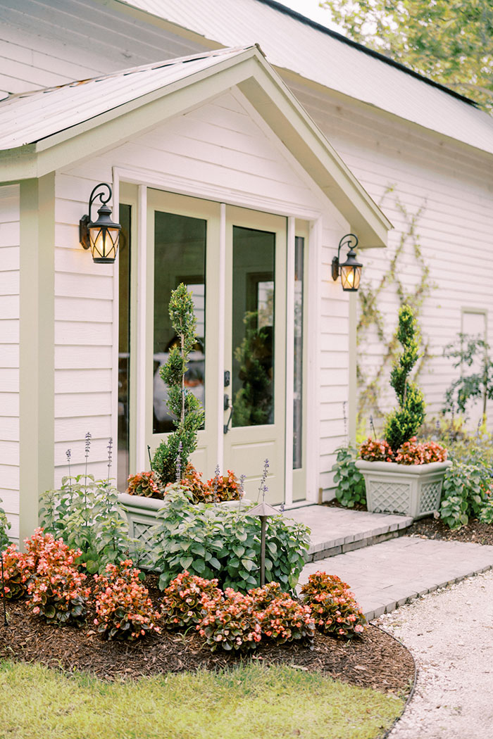 Gracie Ballroom entrance with flowering plants on either side