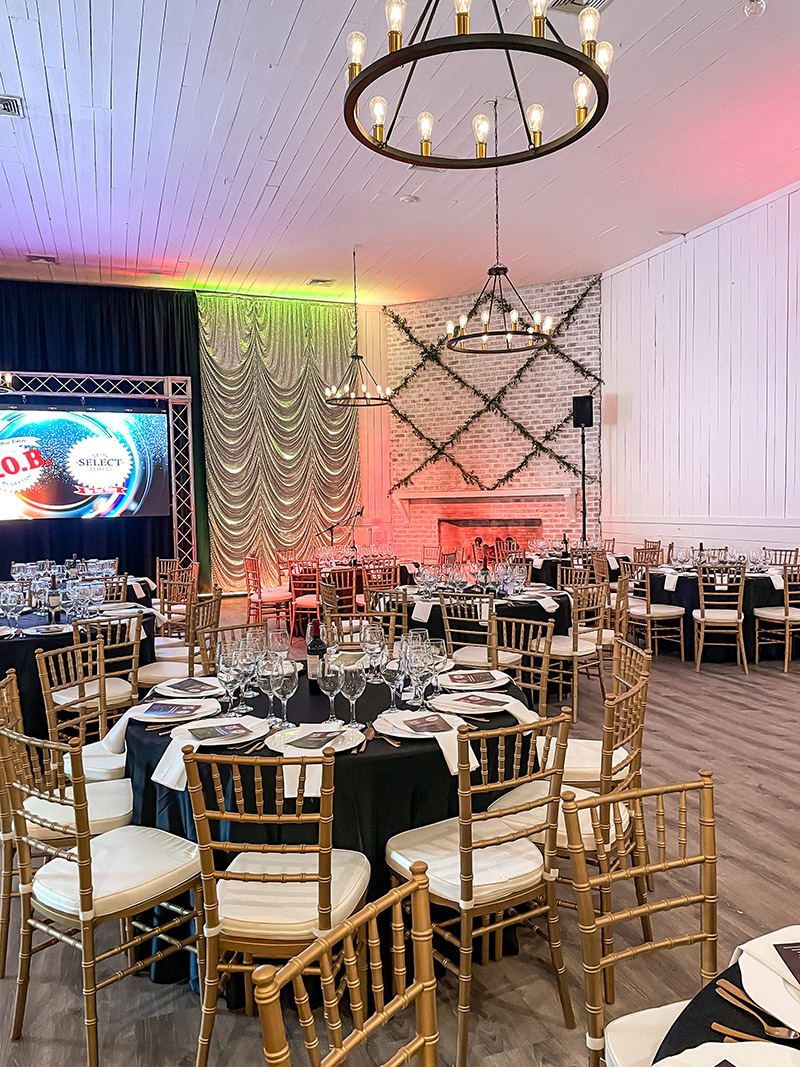 Gracie Ballroom at Hewitt Oaks decorated with colorful lighting and tables for an awards banquet