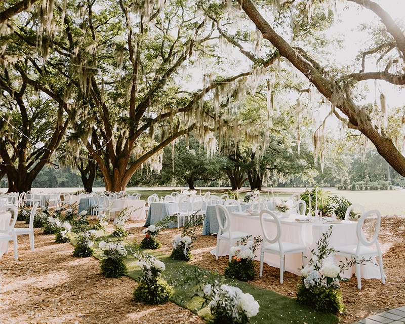 tables set for a fancy event under the Angel Oaks on a sunny day at Hewitt Oaks