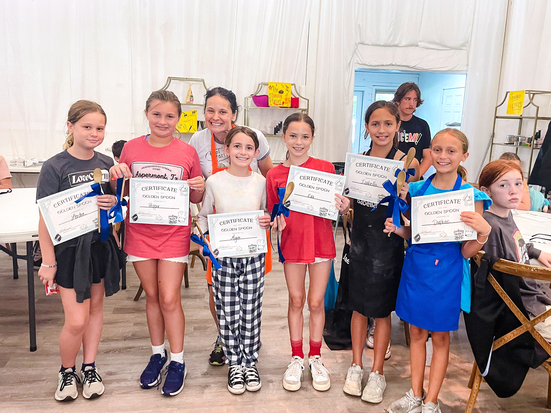 kids proudly showing off the certificates they received at Hewitt Oaks Kids Baking Camp