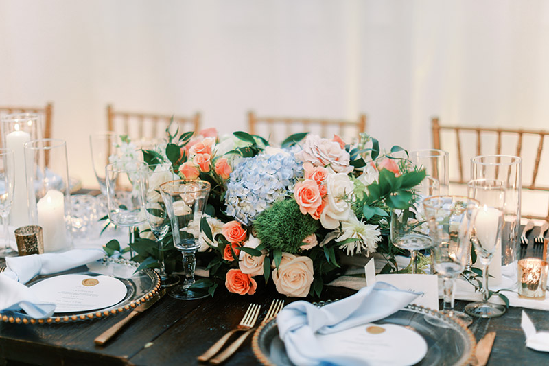 Floral centerpiece with blue hydrangea and pink roses