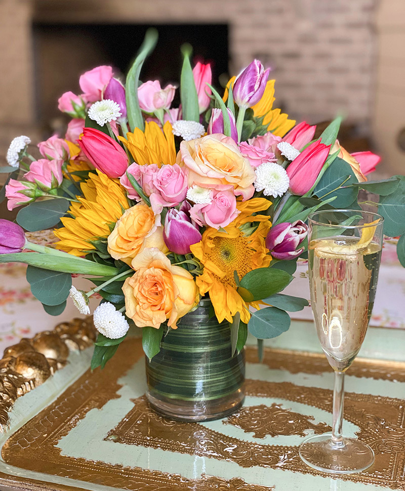 Mother's Day bouquet with spring blooms and a glass of prosecco