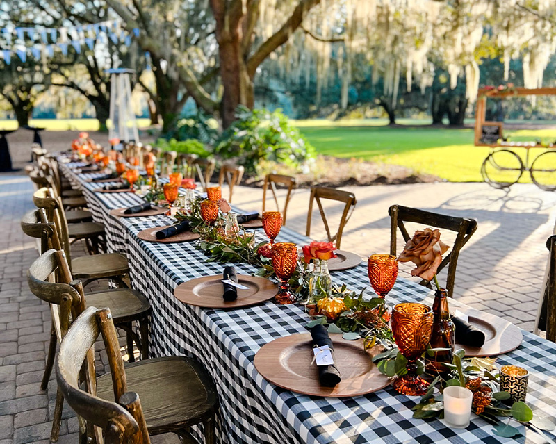 A long table with black and white checkered tablecloth, ready for a classic and elegant dining experience.