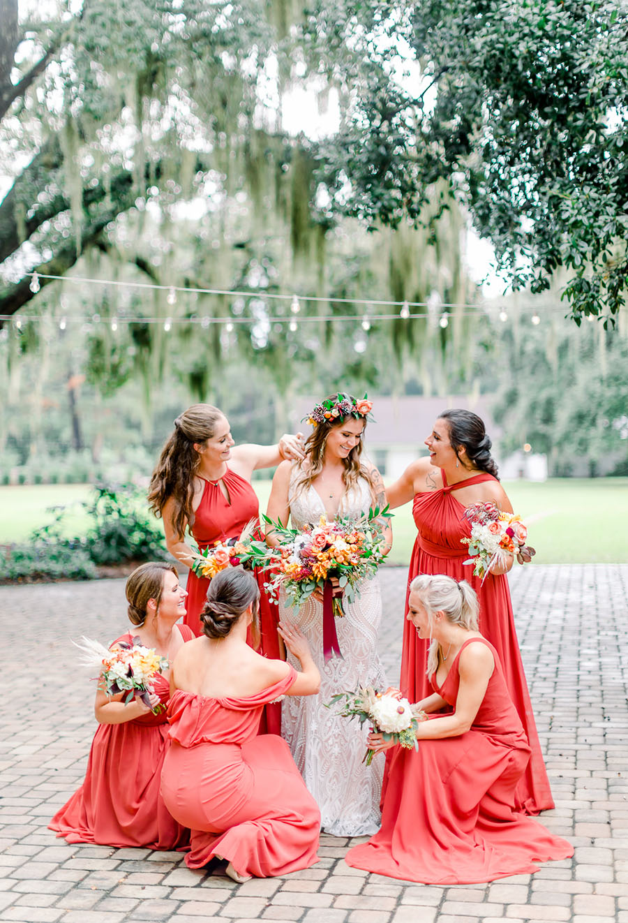 bridesmaids gathered around a bride holding tropical inspired bouquets