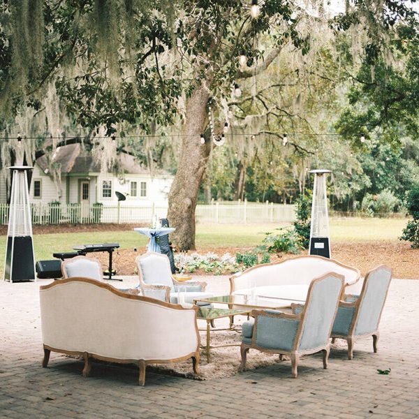 An outdoor lounge nestled among lush trees.