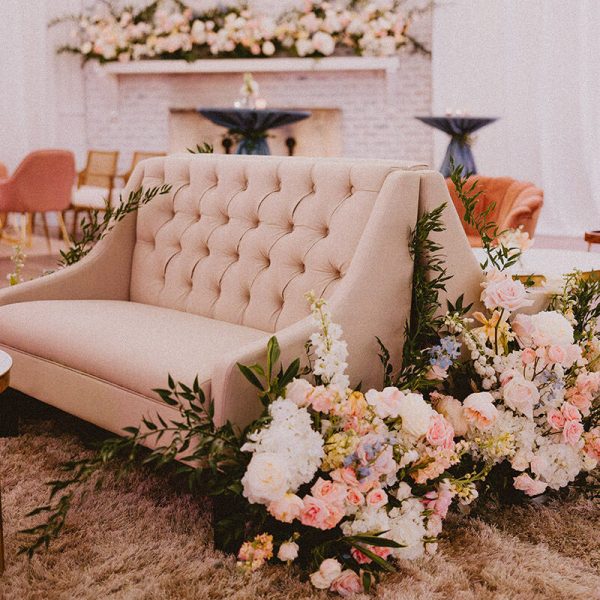 A close-up view of an indoor lounge with a pink theme and floral decorations.