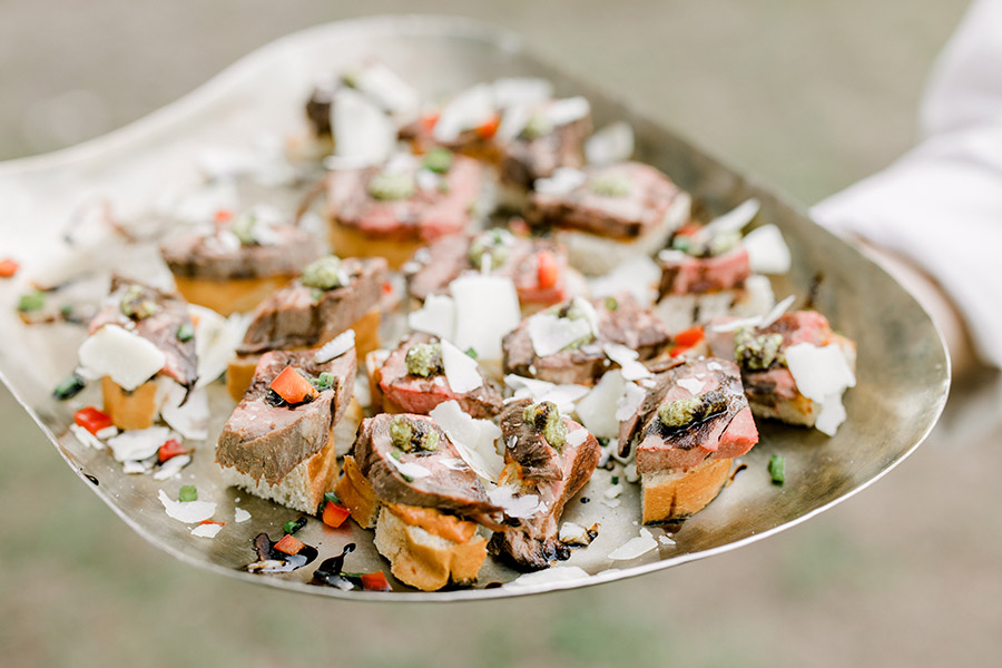 beef crostini hors d'oeuvres on a serving tray